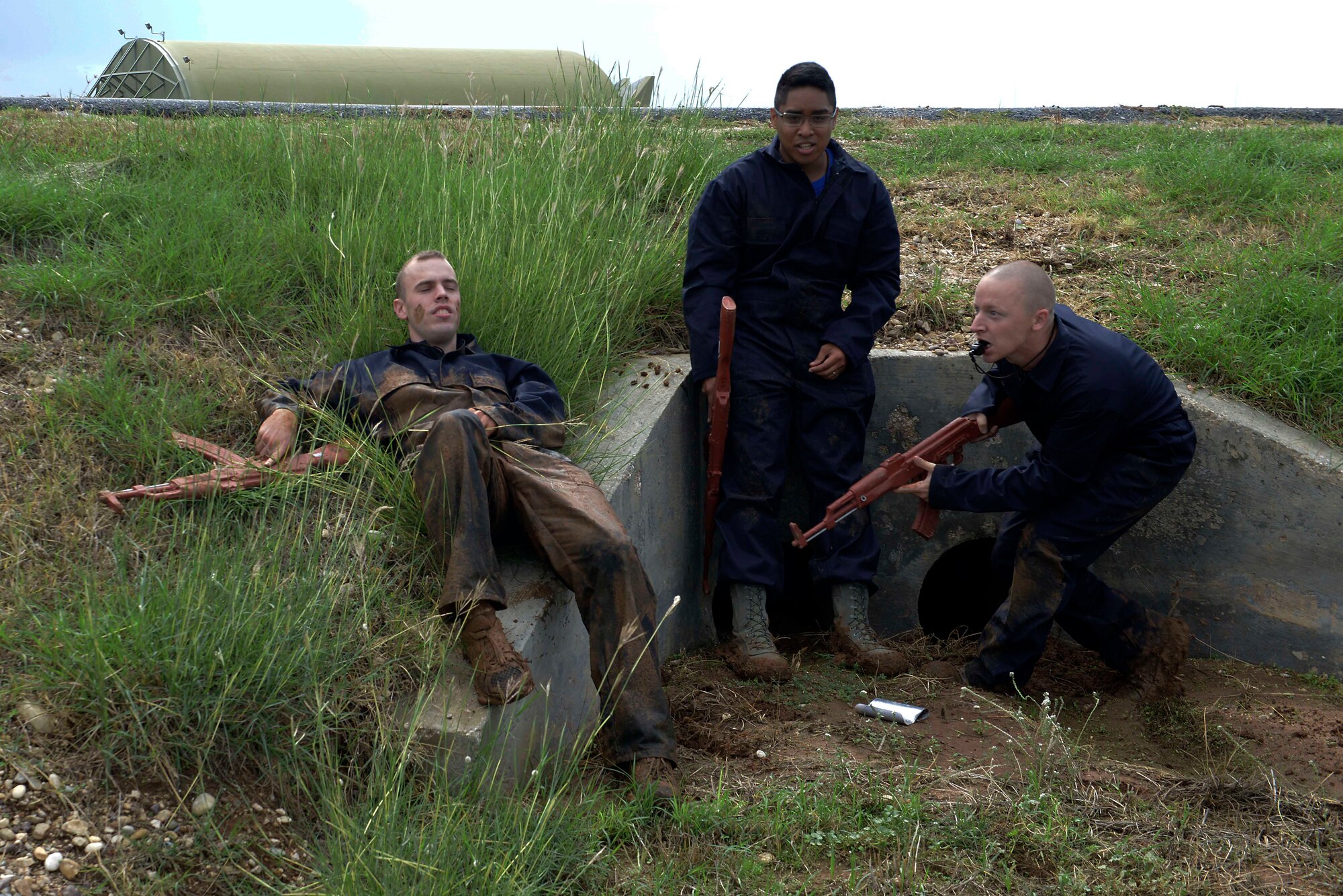 Airmen from the 39th Air Base Wing, acting as aggressive forces, simulate an injury and hiding from first responders during a wing-wide exercise Oct. 2, 2015, at Incirlik Air Base, Turkey.  The exercise was held to test the base’s first responders’ skills and readiness (U.S. Air Force photo by Senior Airman Krystal Ardrey/Released)