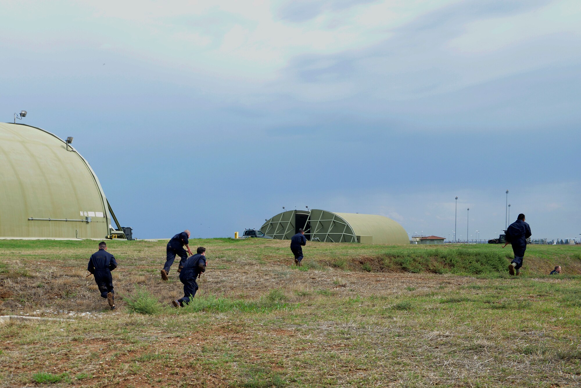 Airmen from the 39th Air Base Wing, acting as aggressive forces, simulate an assault on an ambush during a wing-wide exercise Oct. 2, 2015, at Incirlik Air Base, Turkey. The exercise was held to test the base’s first responders, allow them to hone their skills and maintain their readiness to respond to emergency situations. (U.S. Air Force photo by Senior Airman Krystal Ardrey/Released)