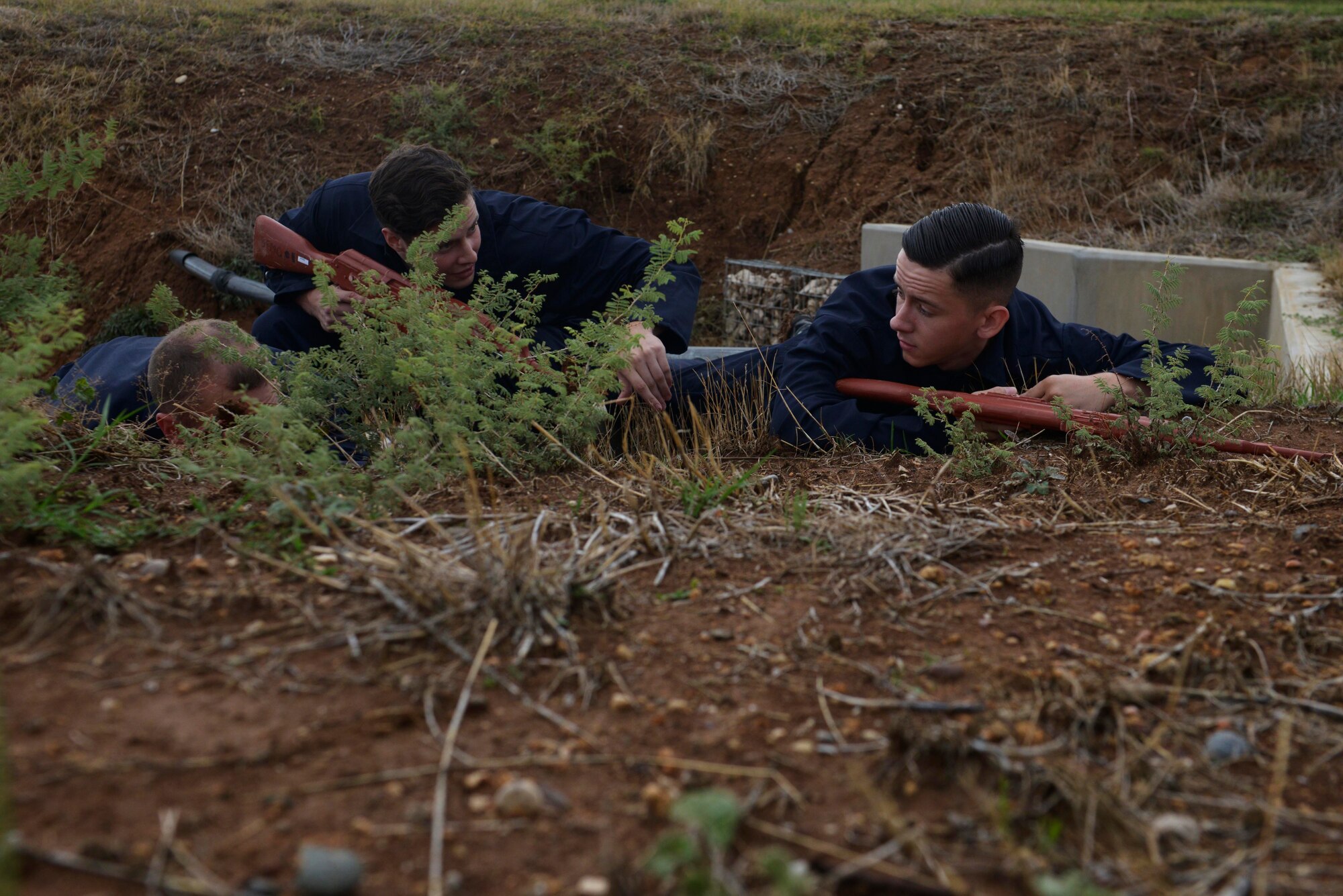 Airmen from the 39th Air Base Wing hide while acting as aggressive forces during a wing-wide exercise Oct. 2, 2015, at Incirlik Air Base, Turkey. As part of the exercise, the 39th Security Forces Squadron defended a convoy from ambush to test their response to an emergency situation. (U.S. Air Force photo by Senior Airman Krystal Ardrey/Released)