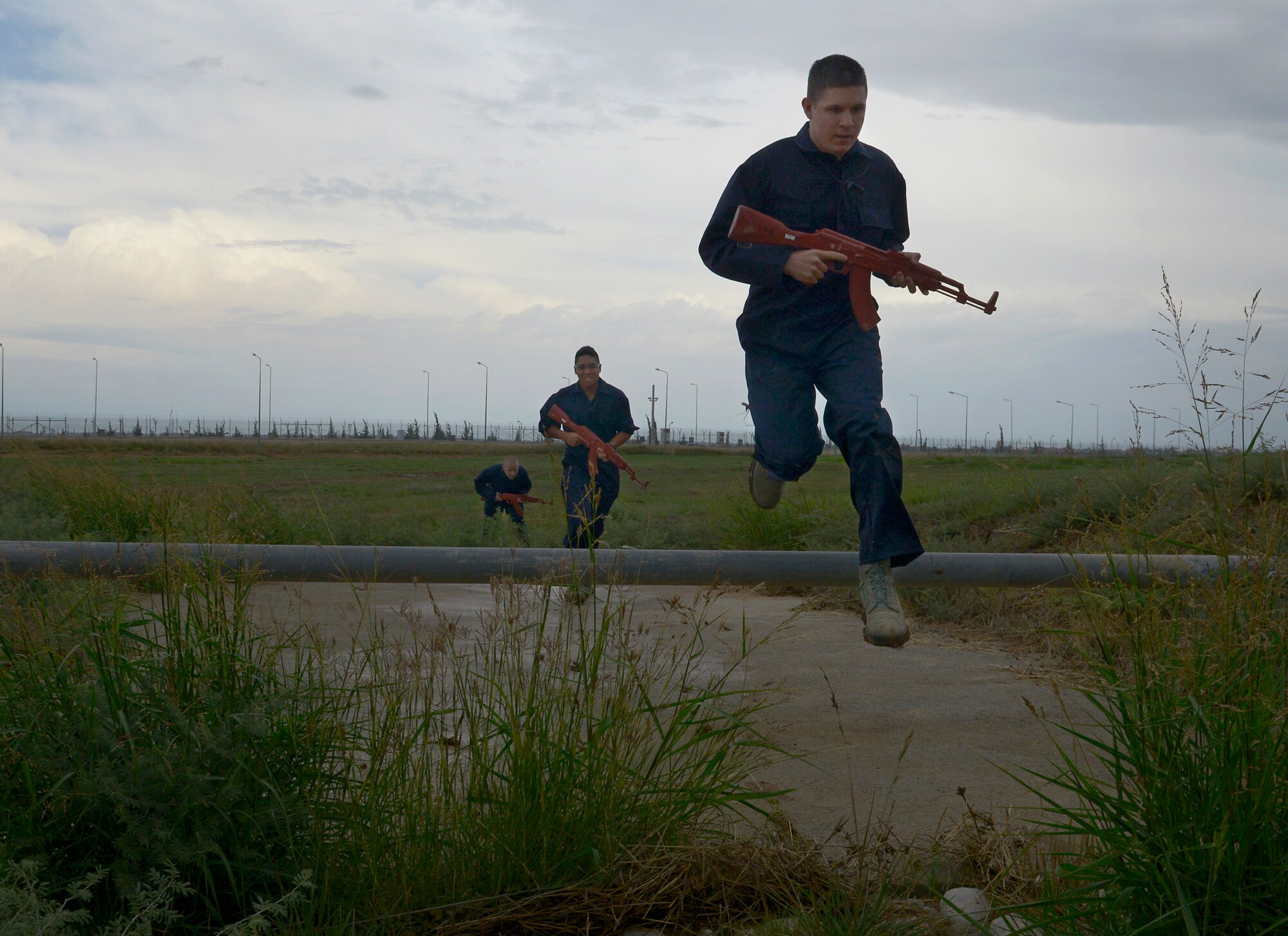 Airmen from the 39th Air Base Wing run into position to attack while acting as aggressive forces during a wing-wide exercise Oct. 2, 2015, at Incirlik Air Base, Turkey. The exercise tested the base's readiness and ability to respond to an emergency at a moment's notice. (U.S. Air Force photo by Senior Airman Krystal Ardrey/Released)