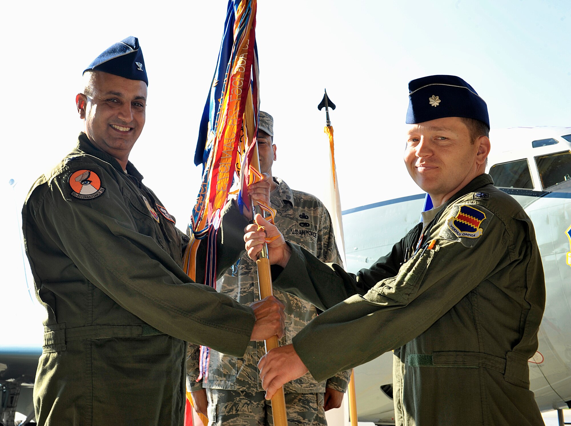 U.S. Air Force Col. Mohan Krishna, 55th Operations Group commander, passes the 82nd Reconnaissance Squadron guidon to Lt. Col. Beau Nicewanner, 82nd RS commander, during the 82nd RS change of command ceremony Oct. 7, 2015, on Kadena Air Base, Japan. Nicewanner leads five flights of reconnaissance professionals and expeditionary aircrews employing WC-135 atmospheric collection aircraft and RC-135 surveillance aircraft variants to execute all aspects of sensitive reconnaissance operations throughout U.S. Pacific Command. (U.S. Air Force photo by Naoto Anazawa)