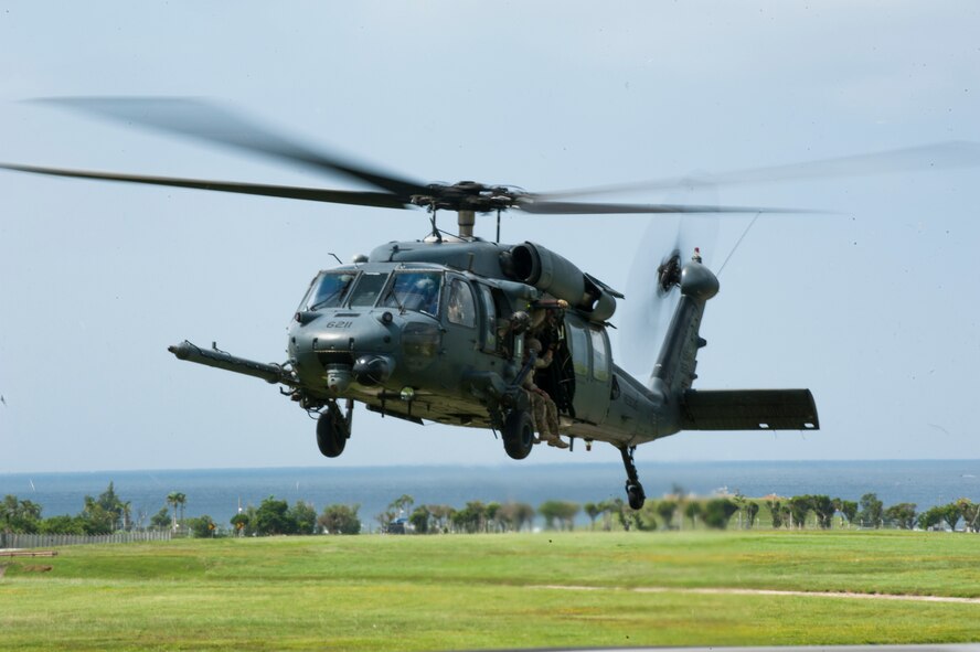 U.S. Air Force pararescuemen prepare to fast-rope from a helicopter Oct. 3, 2015, on Kadena Air Base, Japan. These Airmen demonstrate methods of retrieval during Rescue Fest, a yearly event that displays the capabilities of the 31st and 33rd Rescue Squadrons. (U.S. Air Force photo by Airman 1st Class Nicholas Emerick)