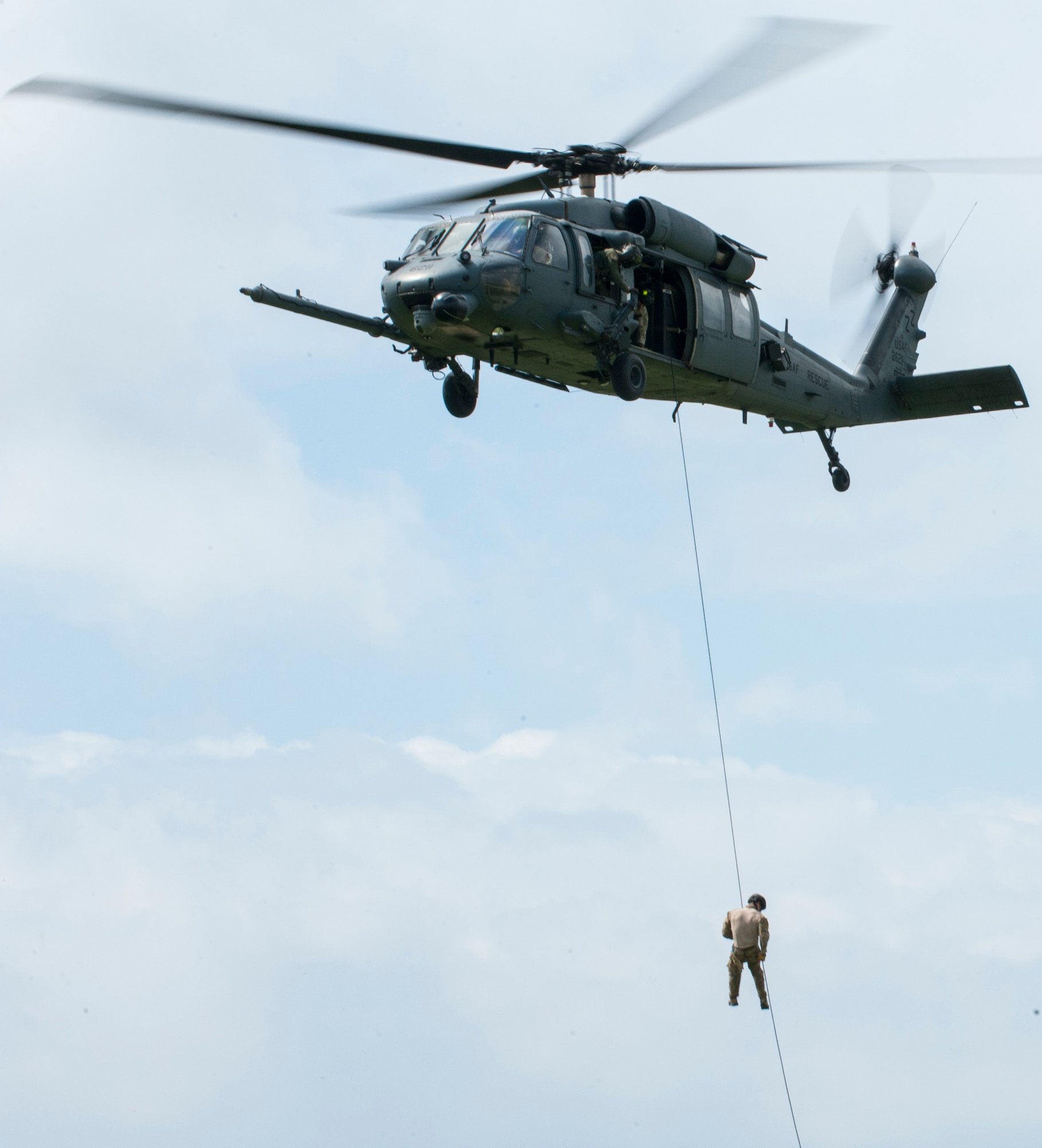 A U.S. Air Force pararescueman fast-ropes from a helicopter Oct. 3, 2015 on Kadena Air Base, Japan. These Airmen demonstrate rescue capabilities of the 31st and 33rd Rescue Squadrons during Rescue Fest, a yearly event held to educate on rescue tactics. (U.S. Air Force photo by Airman 1st Class Nicholas Emerick)