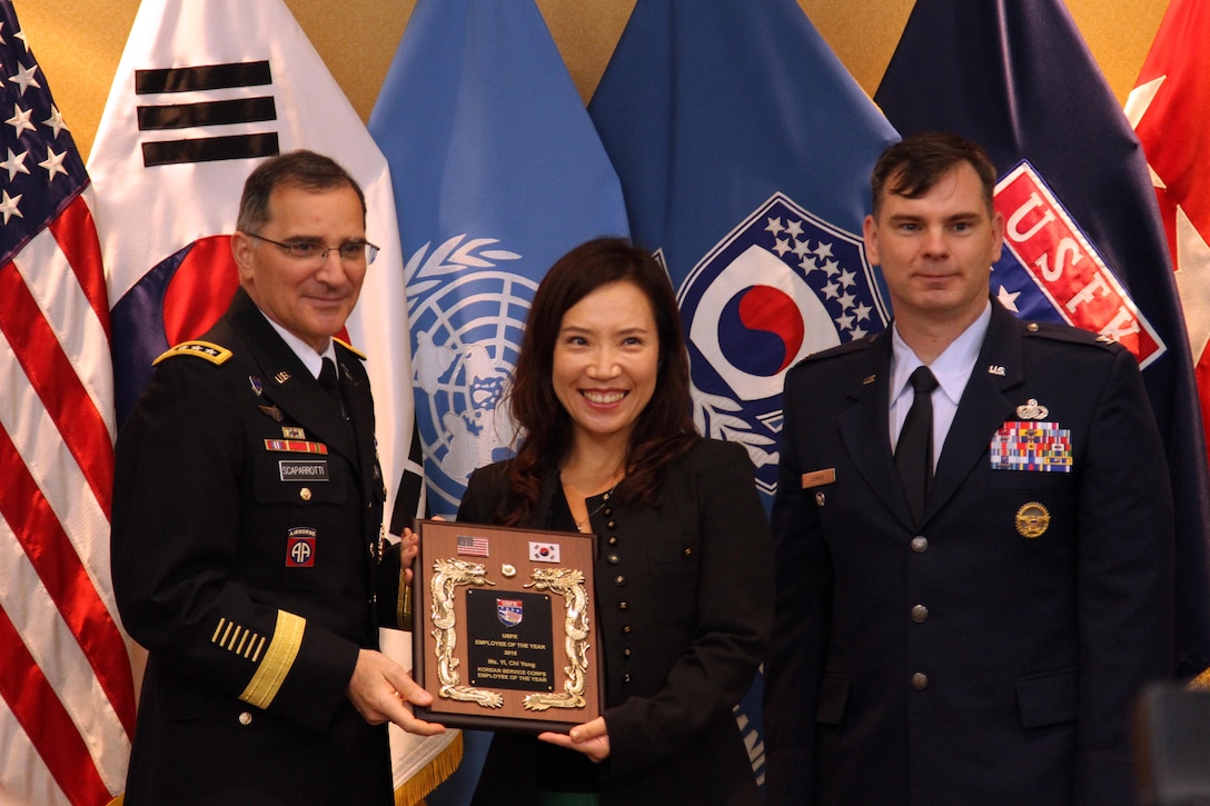 Gen. Curtis M. Scaparrotti, United Nations Command, Combined Forces Command, U.S. Forces Korea commander and Col. Yancey S. Cowen, Assistant Chief of Staff J1, present Ms. Yi, Chi Yong a community relations specialist with the Korean Service Corps Employee of the Year award during the 2015 USFK Civilian Employees of the Year award ceremony October 8, 2015 at the Dragon Hill Lodge. (Photo by CPL Choi, Woo Hyuk, USFK Public Affairs)