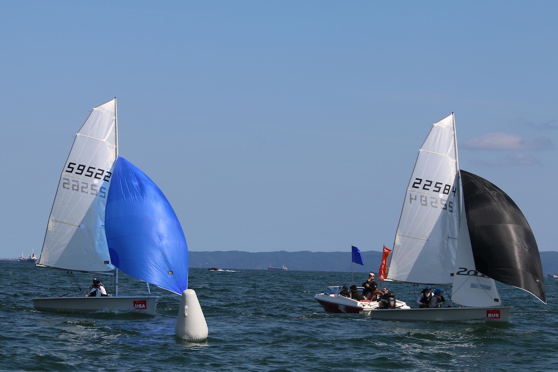 U.S. Women's Team cross the finish line behind Russia during their final race of the Women's two-person dingy competition. Skipper Navy Ensign Mary Hall and crew Navy Lt. Trisha Kutkiewiczplaced better than Russia during the 11 race competition to outscore Russia by one point to capture the gold medal.