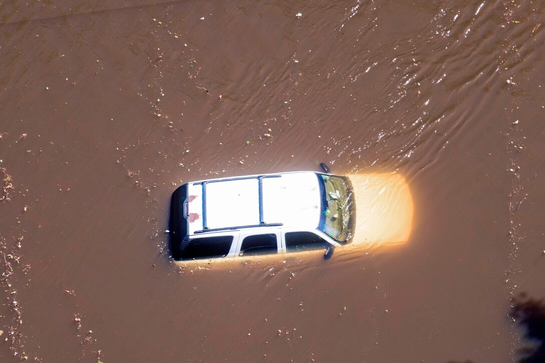 An aerial view taken from a Coast Guard helicopter showing a stranded vehicle in flooded waters caused by Hurricane Joaquin in the South Carolinian counties of Berkley and Williamsburg, S.C., Oct. 7, 2015. U.S. Coast Guard photo by Petty Officer 1st Class Stephen Lehmann  