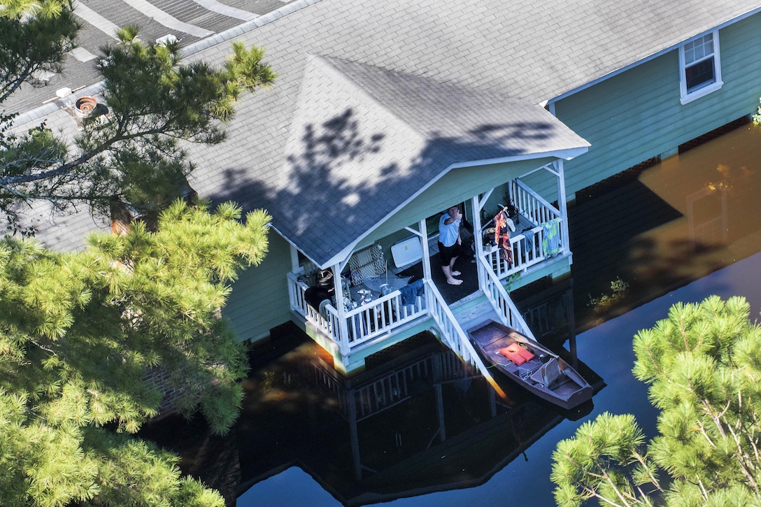 An aerial view taken from a Coast Guard helicopter shows a stranded resident giving the thumbs up from the continuing effects of flooding caused by Hurricane Joaquin in the South Carolinian counties of Berkley and Williamsburg, S.C., Oct. 7, 2015. U.S. Coast Guard photo by Petty Officer 1st Class Stephen Lehmann  