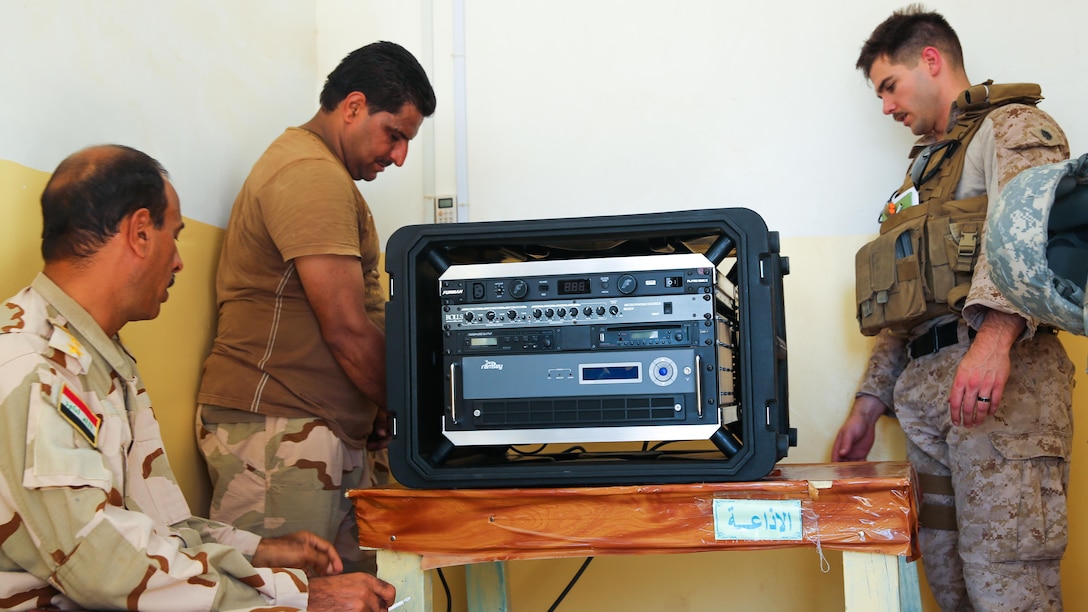 U.S. Marine Staff Sgt. Eric Alabiso, right, a military information operations advisor with Task Force Al Asad, helps an Iraqi soldier with the 7th Iraqi Army Division set up a Radio in a Box at Al Asad Air Base, Iraq, Sept. 28, 2015. The RIAB was provided by Iraq’s Ministry of Defense through the Iraq Train and Equip Fund. The fund was established by Combined Joint Task Force – Operation Inherent Resolve, a part of the multinational coalition force that helps improve the Iraqi military’s ability to fight against the Islamic State of Iraq and the Levant  by providing training and advice to its soldiers and officers.  
