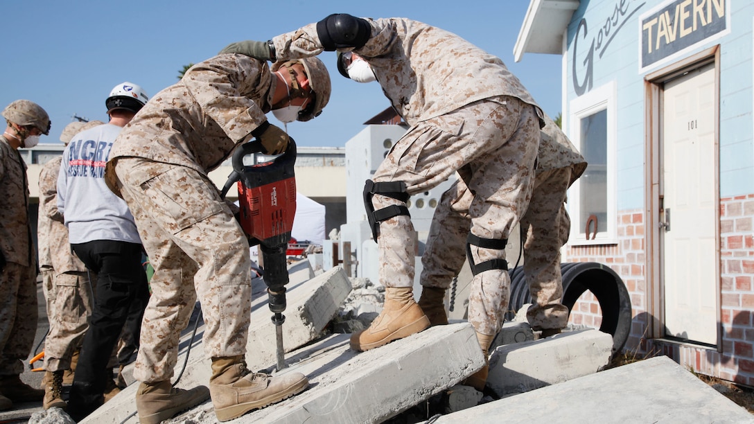 Marines cut through concrete slabs with a jackhammer during urban search and rescue training at Treasure Island, Oct. 7, 2015, as part of San Francisco Fleet Week 2015. The event featured demonstrations and hands-on training with tools commonly used for rescue missions during disaster relief.