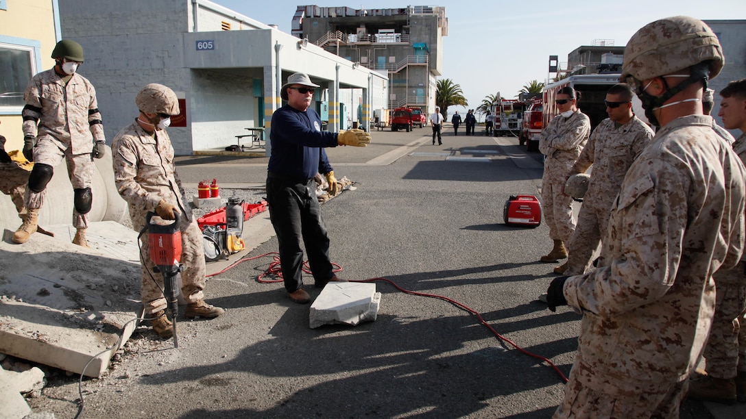 Pat Gardner, a retired deputy chief with the San Francisco Fire Department, instructs Marines during urban search and rescue training at Treasure Island, Oct. 7, 2015, as part of San Francisco Fleet Week 2015. The event featured demonstrations and hands-on training with tools commonly used for rescue missions during disaster relief.