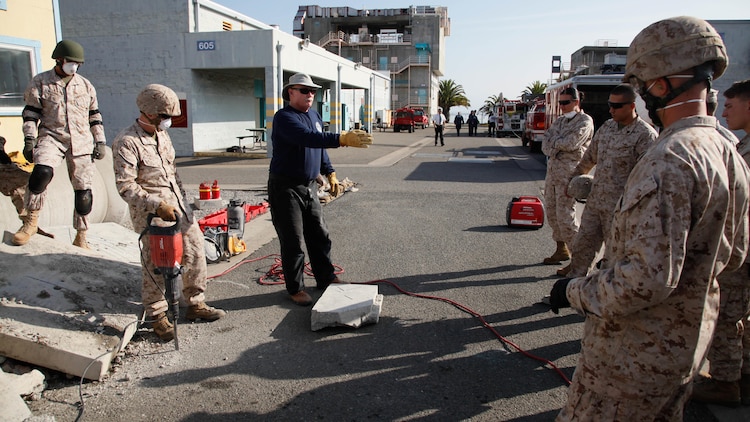 Pat Gardner, a retired deputy chief with the San Francisco Fire Department, instructs Marines during urban search and rescue training at Treasure Island, Oct. 7, 2015, as part of San Francisco Fleet Week 2015. The event featured demonstrations and hands-on training with tools commonly used for rescue missions during disaster relief.