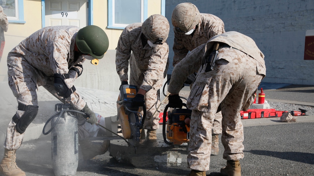Marines cut through concrete blocks using saws and water during urban search and rescue training at Treasure Island, Oct. 7, 2015, as part of San Francisco Fleet Week 2015. The event featured demonstrations and hands-on training with tools commonly used for rescue missions during disaster relief.
