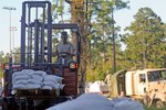 U.S. Army Spc. Joshua Monk, assigned to the 1052nd Transportation Company, South Carolina National Guard in Kingstree South Carolina, uses a forklift to unload sandbags at the 8 Oaks Park in Georgetown on Oct. 7, 2015. The sandbags were delivered in response to widespread flooding in the area as a result of heavy rain. The South Carolina National Guard partnered with federal, state and local emergency management agencies and first responders to provide assistance. 