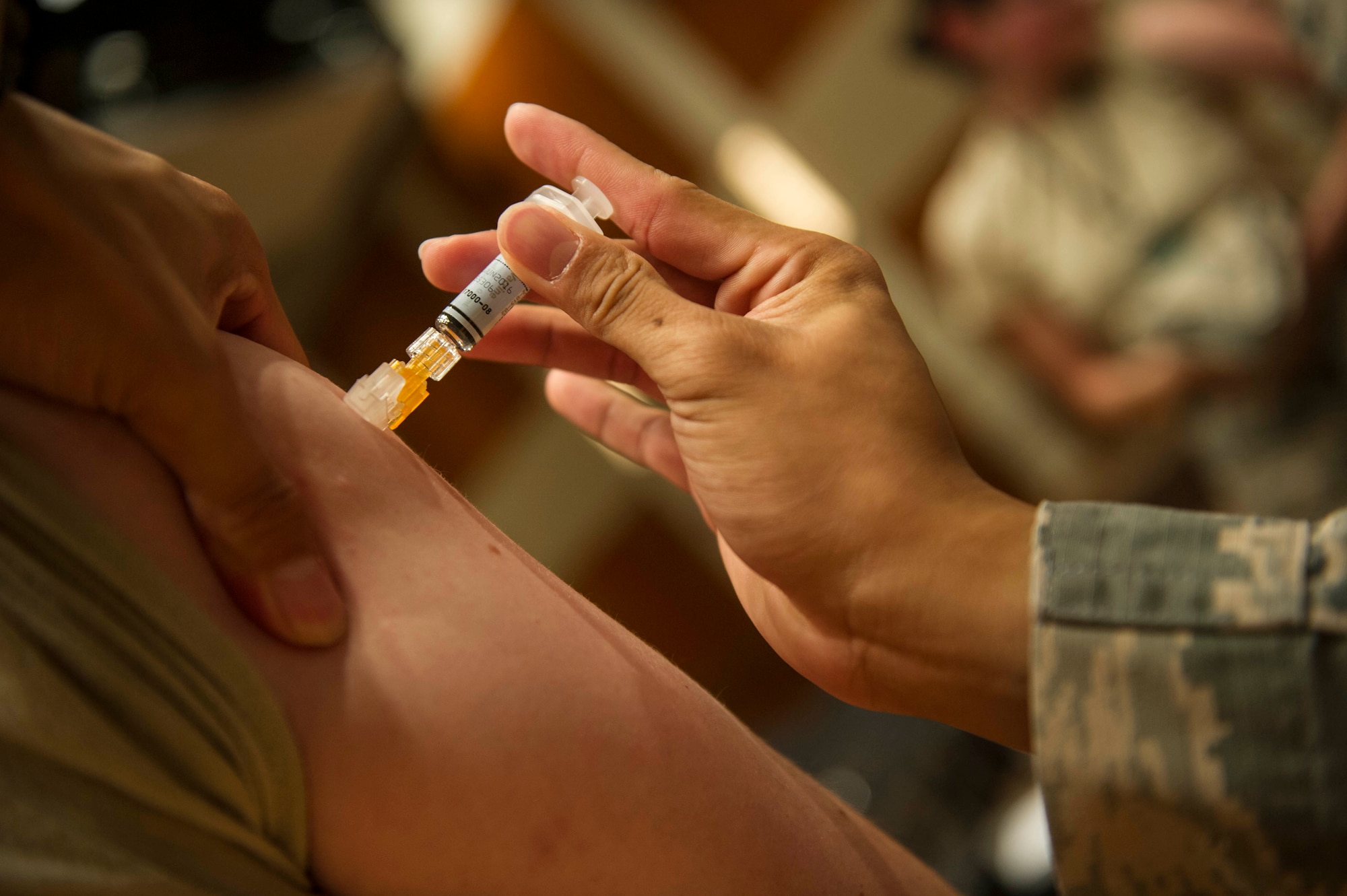 Medical technicians from the 88th Medical Group administer annual influenza vaccinations at the National Air and Space Intelligence Center Oct. 6, 2015. It is mandatory for all military and health care personnel to receive the vaccine annually, and highly recommended for everyone more than 6 months old. (U.S. Air Force photo by Senior Airman Justyn Freeman)