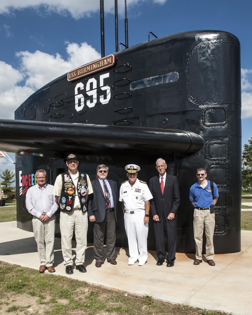 Former members of the USS Birmingham submarine stand next to the ships’ sail with Rear Adm. John King, DLA Land and Maritime commander, Sept. 23 after the ribbon cutting ceremony to open the brand new Mission Park on Defense Supply Center Columbus. A fitness trail links land and sea vehicles, weapons systems and historic displays that reflect DSCC’s contributions to the nation’s defense since 1918 at the park.