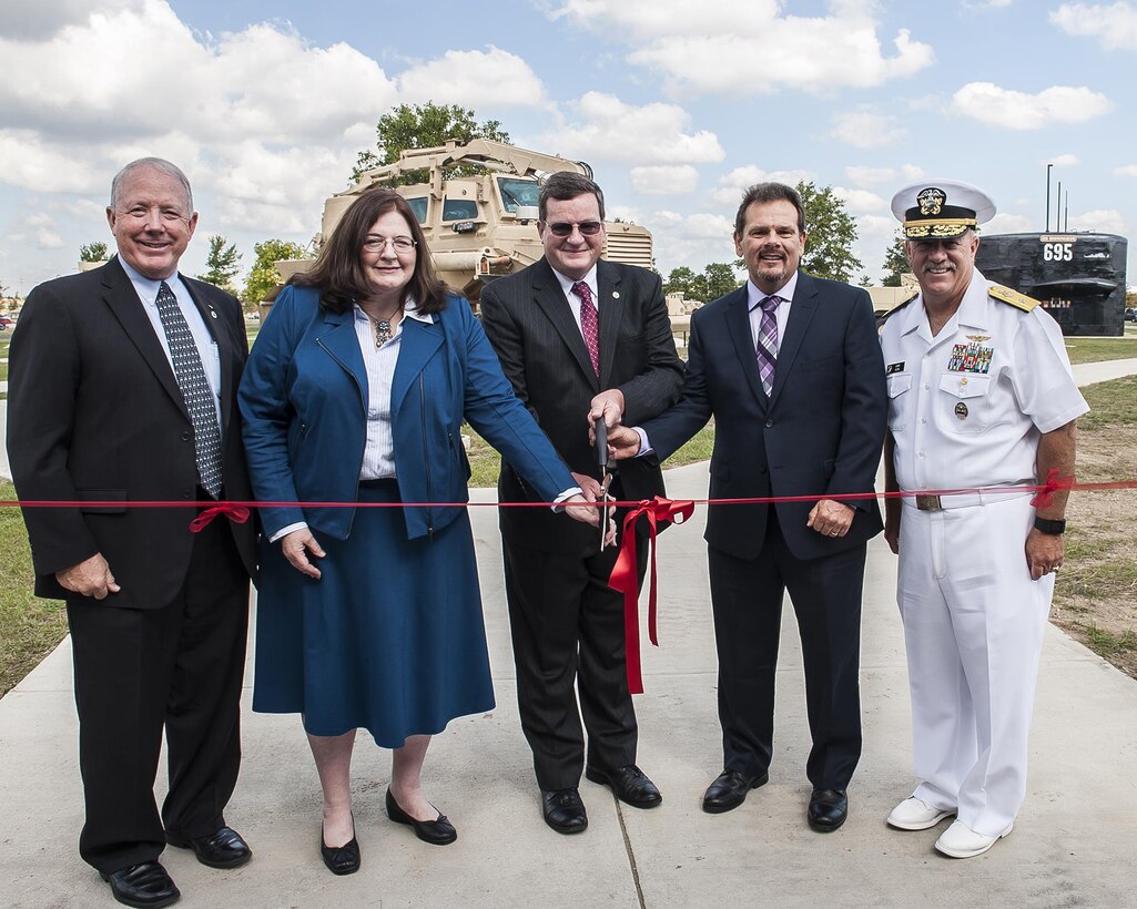 On Sept. 23 Defense Supply Center Columbus officials revealed the new Mission Park that represents the installation’s support organizations and workforce whose efforts ensure the ultimate success of the nation’s military services. Helping with the ribbon cutting ceremony were (l-r): James McClaugherty, Land and Maritime deputy commander; Laura Webb; Dan Bell, Installation Site director; Shawn McKinney; and Navy Rear Adm. John King, DLA Land and Maritime commander.