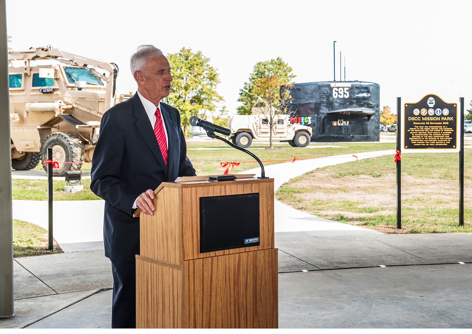 Navy Capt. (Ret.) Paul Callahan speaks during the ribbon cutting ceremony to open up brand new Mission Park on Defense Supply Center Columbus Sept. 23. Callahan was the first commanding officer of the USS Birmingham submarine, whose sail now resides inside the new park.