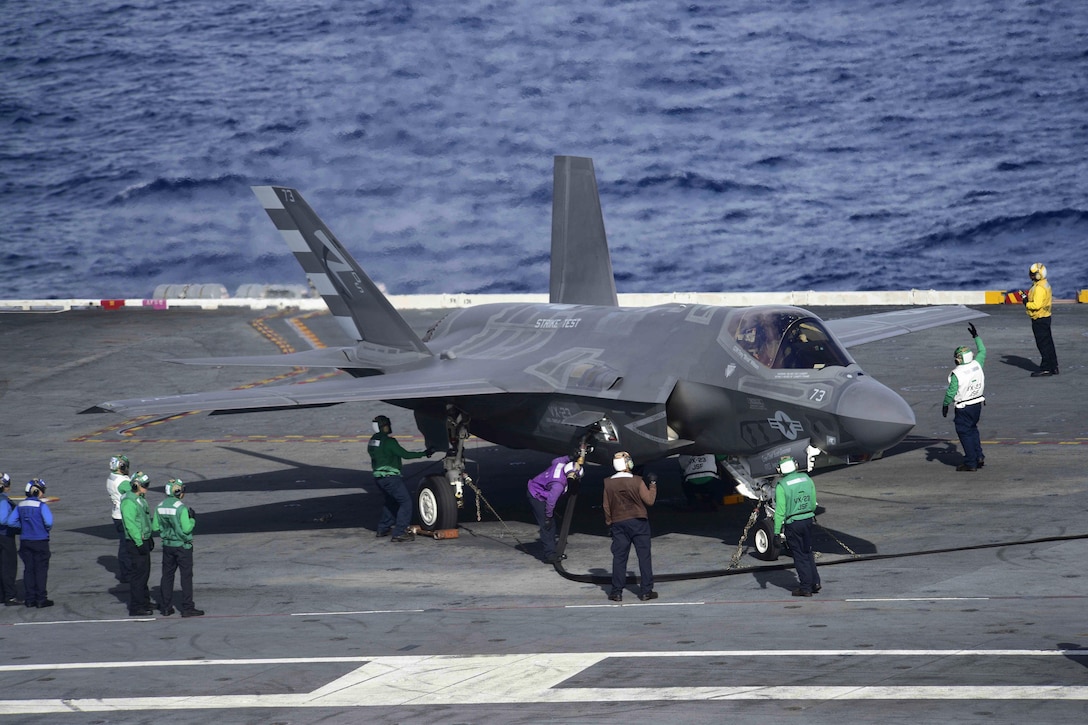 U.S. sailors refuel an F-35C Lightning II carrier-variant joint strike fighter on the flight deck of the aircraft carrier USS Dwight D. Eisenhower in the Atlantic Ocean, Oct. 4, 2015. The F-35C Lightning II Patuxent River Integrated Test Force is currently conducting follow-on sea trials aboard the Eisenhower. The sailors are assigned to Air Test and Evaluation Squadron 23. U.S. Navy photo by Petty Officer 3rd Class Jameson E. Lynch