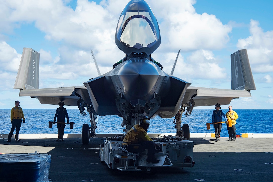 Navy sailors move an F-35C Lightning II carrier-variant joint strike fighter aboard the aircraft carrier USS Dwight D. Eisenhower in the Atlantic Ocean, Oct. 6, 2015. U.S. Navy photo by Seaman Anderson W. Branch
