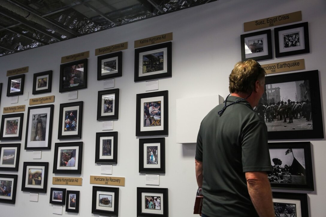 A San Francisco resident observes the artwork showcased at the Veterans' Art Exhibit hosted by the Cannery on Fisherman's Wharf in San Francisco, as part of San Francisco Fleet Week, Oct. 7, 2015. The art exhibit welcomes members of the public Oct. 7-11, from 10 am - 5 pm. SFFW ’15 is a week-long event that blends a unique training and education program, bringing together key civilian emergency responders and Naval crisis-response forces to exchange best practices focused on humanitarian assistance disaster relief with particular emphasis on defense support to civil authorities.