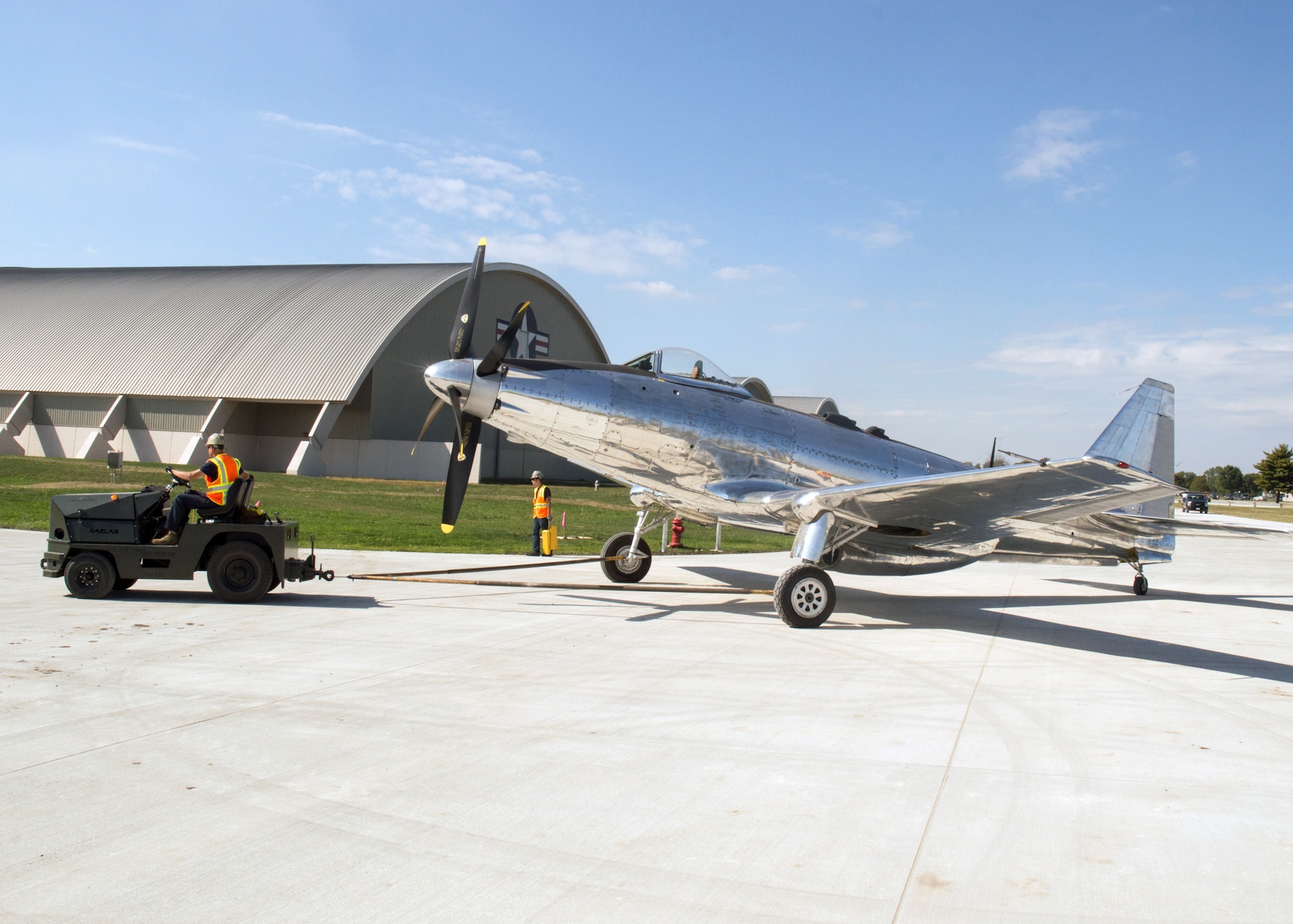 Restoration staff move the Fisher P-75A into the new fourth building at the National Museum of the U.S. Air Force on Oct. 7, 2015. (U.S. Air Force photo by Ken LaRock)