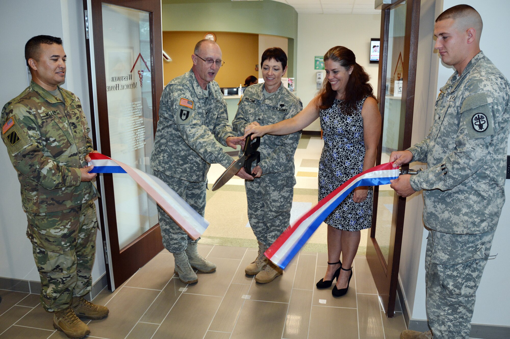 BAMC Commander Col. Evan M. Renz, SRMC Commander Brig. Gen. Barbara Holcomb and Dr. Darii Ann Lane, clinic OIC, cut the ribbon to officially open Westover Medical Home in Northwest San Antonio, Sept. 18, 2015. Westover, BAMC's newest community-based clinic, is open to all TRICARE beneficiaries in the surrounding area. The clinic provides primary care, behavioral health services, on-site laboratory capabilities and a pharmacy. (U.S. Army photo/Robert T. Shields)