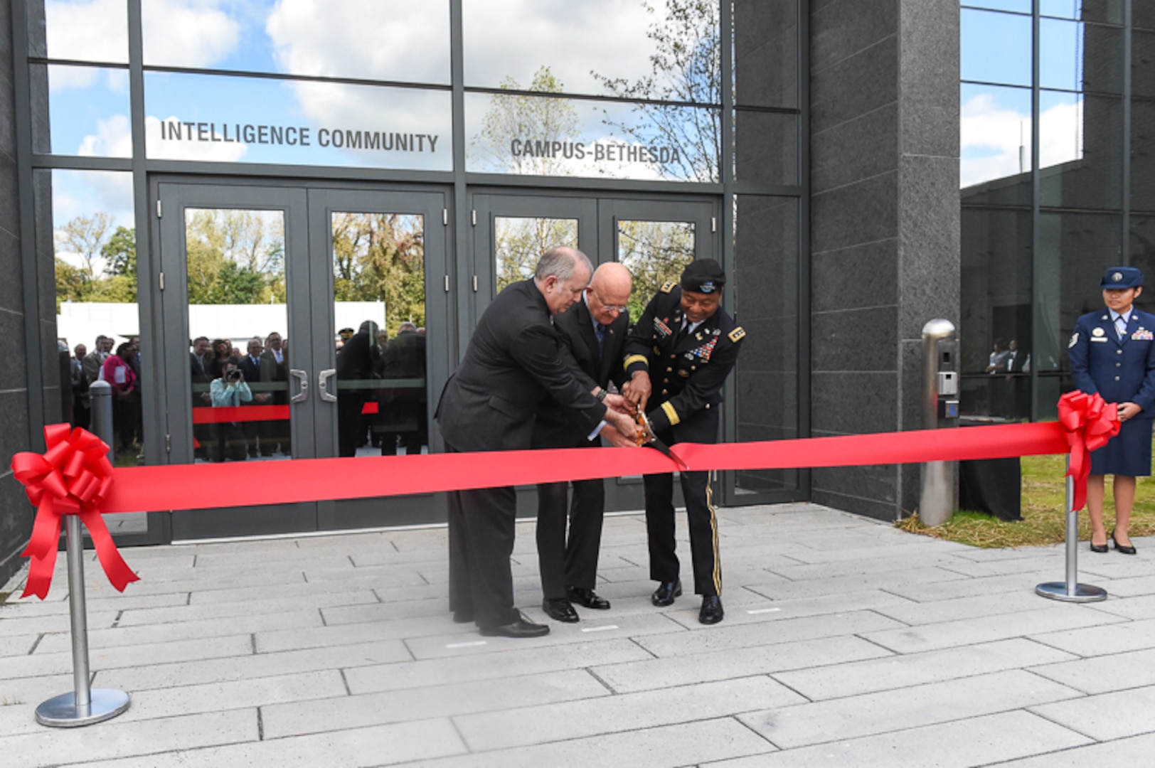 Douglas H. Wise, deputy director of the Defense Intelligence Agency, James R. Clapper, director of national intelligence, and Lt. Gen. Thomas P. Bostick, chief of engineers and commanding general of the U.S. Army Corps of Engineers, cut the ribbon during the opening of the Intelligence Community Campus-Bethesda, in Bethesda, Maryland, October 7, 2015.