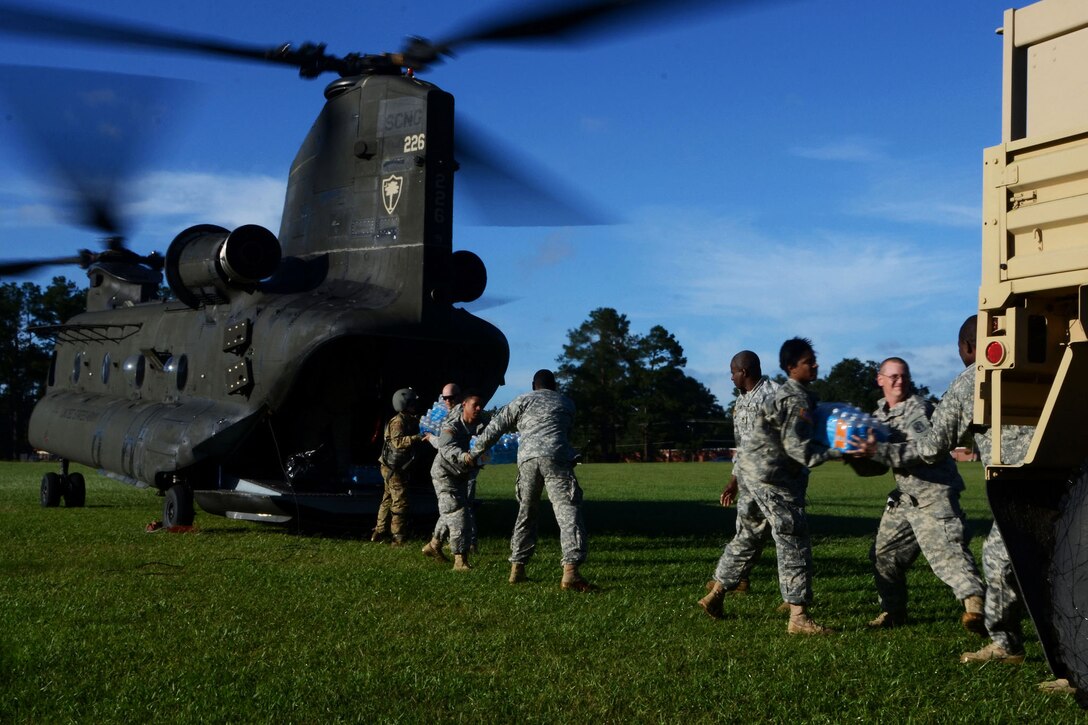 South Carolina Army National Guardsmen move supplies from a CH-47 Chinook helicopter in Kingstree, S.C., Oct. 6, 2015, during statewide flood response efforts. South Carolina National Guard photo by Air Force Airman Megan Floyd
