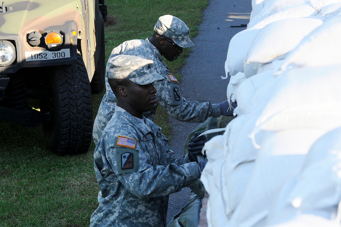 South Carolina Army National Guardsmen unload sandbags at the 8 Oaks Park near Georgetown, S.C., Oct. 7, 2015. The soldiers are assigned to the 1052nd Transportation Company. South Carolina National Guard photo by Army Sgt. Kevin Pickering