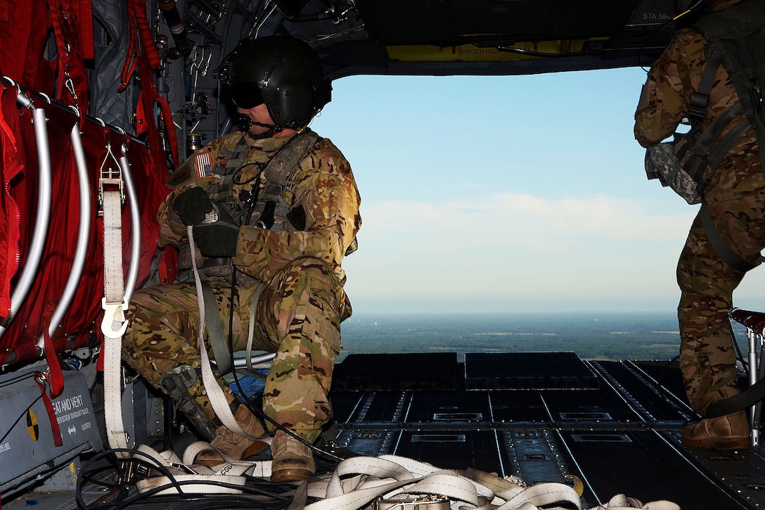 Army Staff Sgt. Robert Greggs adjusts ropes in a Chinook helicopter during a statewide flood response in Kingstree, S.C., Oct. 6, 2015. Greggs is a flight engineer assigned to Detachment 1, 2nd Battalion, 238th Aviation Regiment, South Carolina Army National Guard. South Carolina National Guard photo by Air Force Airman Megan Floyd