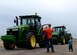 ALTUS AIR FORCE BASE, Okla. – U.S. Air Force Lt. Col. Brian Collins, 97th Operation Support Squadron commander and his son, watch as Airmen learn how to drive tractors during a Farm City tour, October 5, 2015. Altus Air Force Base Airmen and their families got the opportunity to tour local farms and learn agriculture processes. (U.S. Air Force photo by Airman 1st Class Nathan Clark/Released)