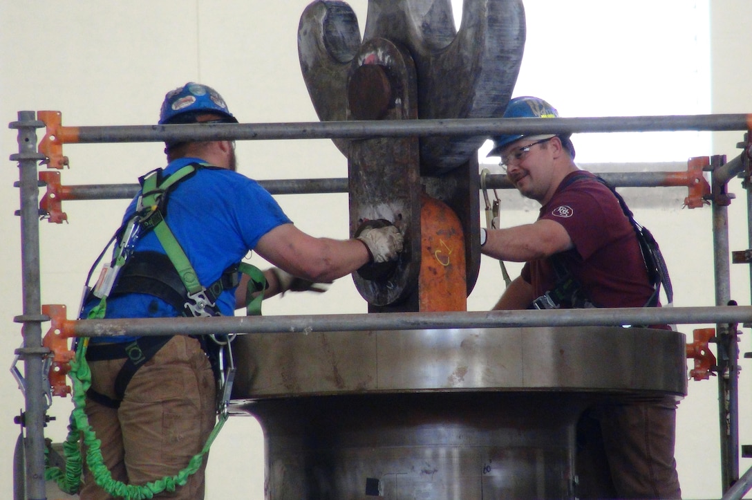 A. J. Conley (Right), turbine mechanic with Voith Hydro, and his supervisor Kye Moss, detach the crane from the turbine runner after its removal from hydropower unit two in the power house at Center Hill Dam Oct. 7, 2015. The U.S. Army Corps of Engineers Nashville District is rehabbing all three units at the dam. 