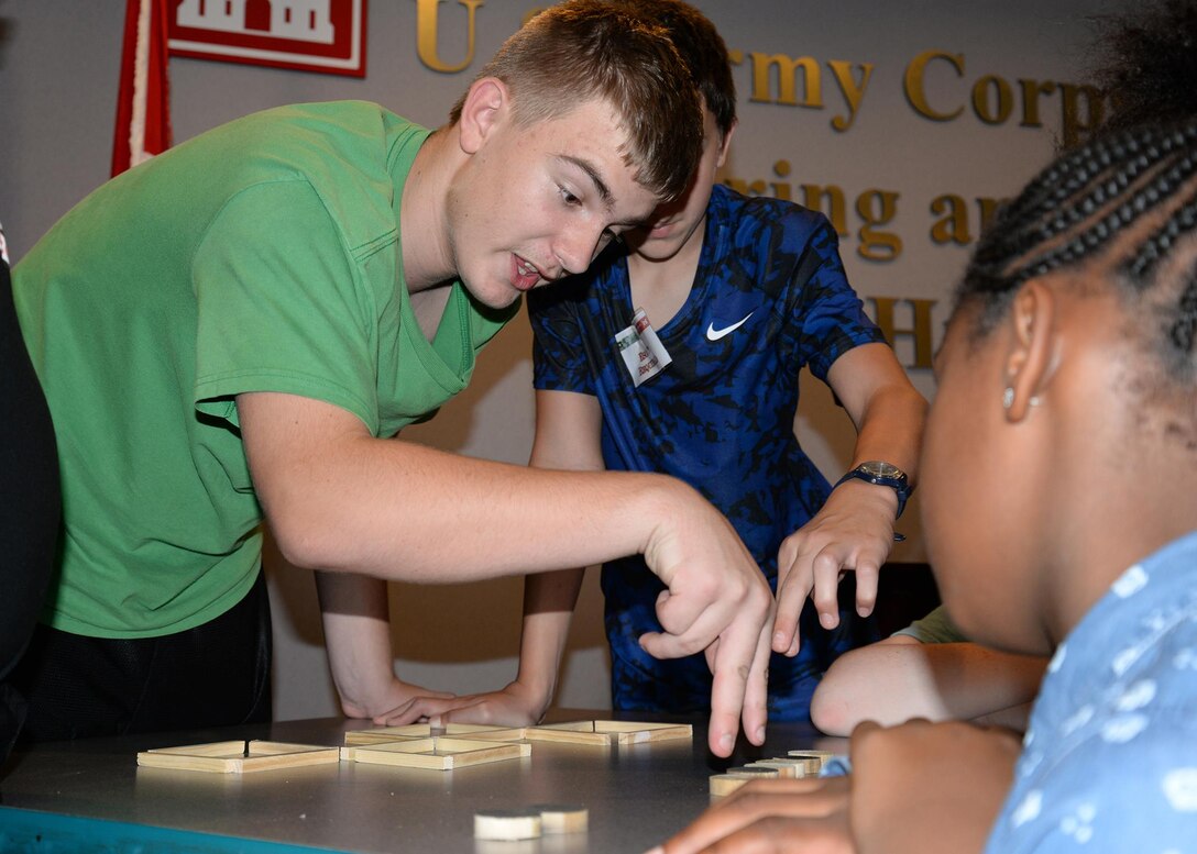 Chandler Sturn works on a problem-solving puzzle during a Science, Technology, Engineering and Math (STEM) event at the U.S. Army Engineering and Support Center, Huntsville Oct. 6. Thirty teens rotated through four stations of problem-solving puzzles set up by the engineers. By participating in the problem-solving puzzles, the teens had a better understanding of what it takes to have a future in a STEM career.