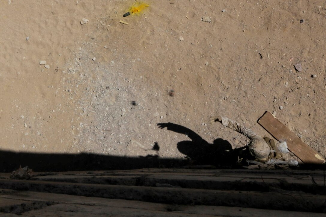 U.S. 5TH FLEET AREA OF OPERATIONS (Sept. 30, 2015) A U.S. Marine with India Company, Battalion Landing Team 3rd Battalion, 1st Marine Regiment, 15th Marine Expeditionary Unit, throws a practice grenade during a military operations in urban terrain exercise. The 15th MEU, embarked aboard the ships of the Essex Amphibious Ready Group, is a forward-deployed, flexible sea-based Marine air-ground task force capable of engaging with regional partners and maintaining regional security.  (U.S. Marine Corps photo by Sgt. Jamean Berry/Released)