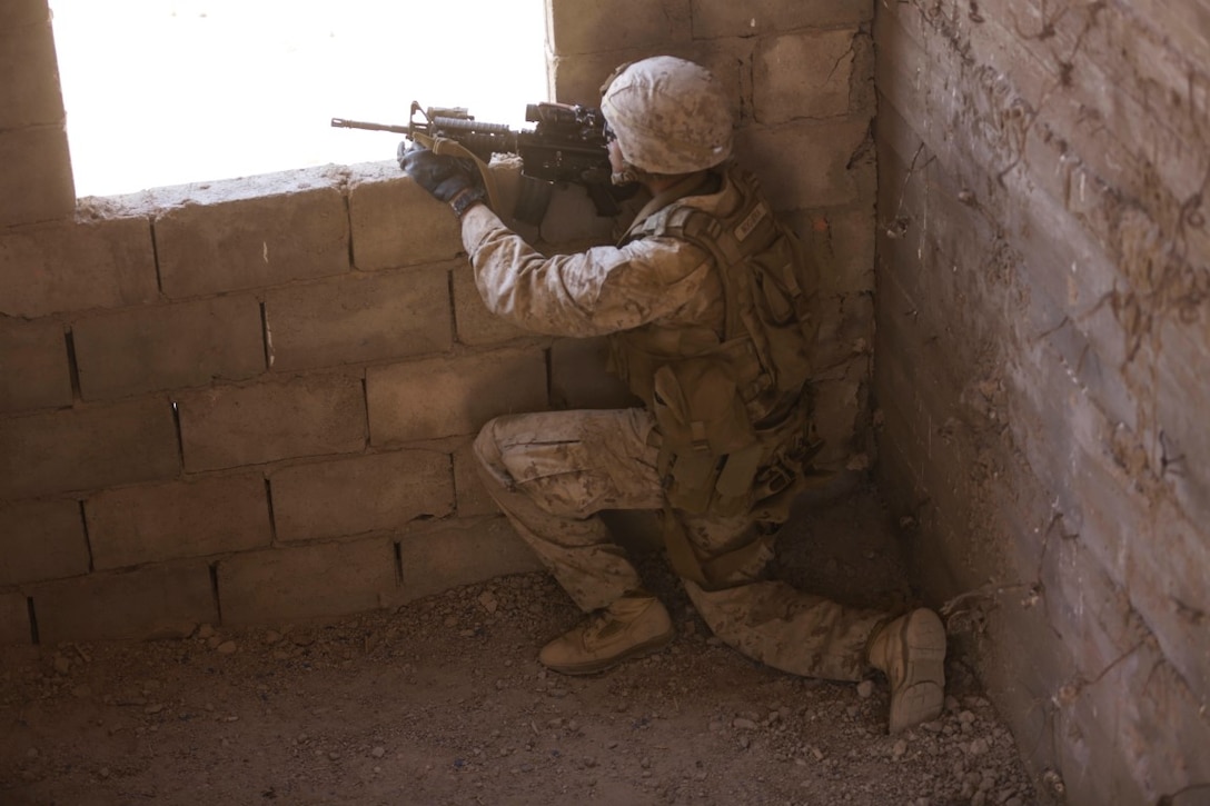 U.S. 5TH FLEET AREA OF OPERATIONS (Sept. 30, 2015)  U.S. Marine Cpl. Brandon Noguera provides security during a military operations in urban terrain exercise. Noguera is a mortarman with India Company, Battalion Landing Team 3rd Battalion, 1st Marine Regiment, 15th Marine Expeditionary Unit.  The 15th MEU, embarked aboard the ships of the Essex Amphibious Ready Group, is a forward-deployed, flexible sea-based Marine air-ground task force capable of engaging with regional partners and maintaining regional security.  (U.S. Marine Corps photo by Sgt. Jamean Berry/Released)