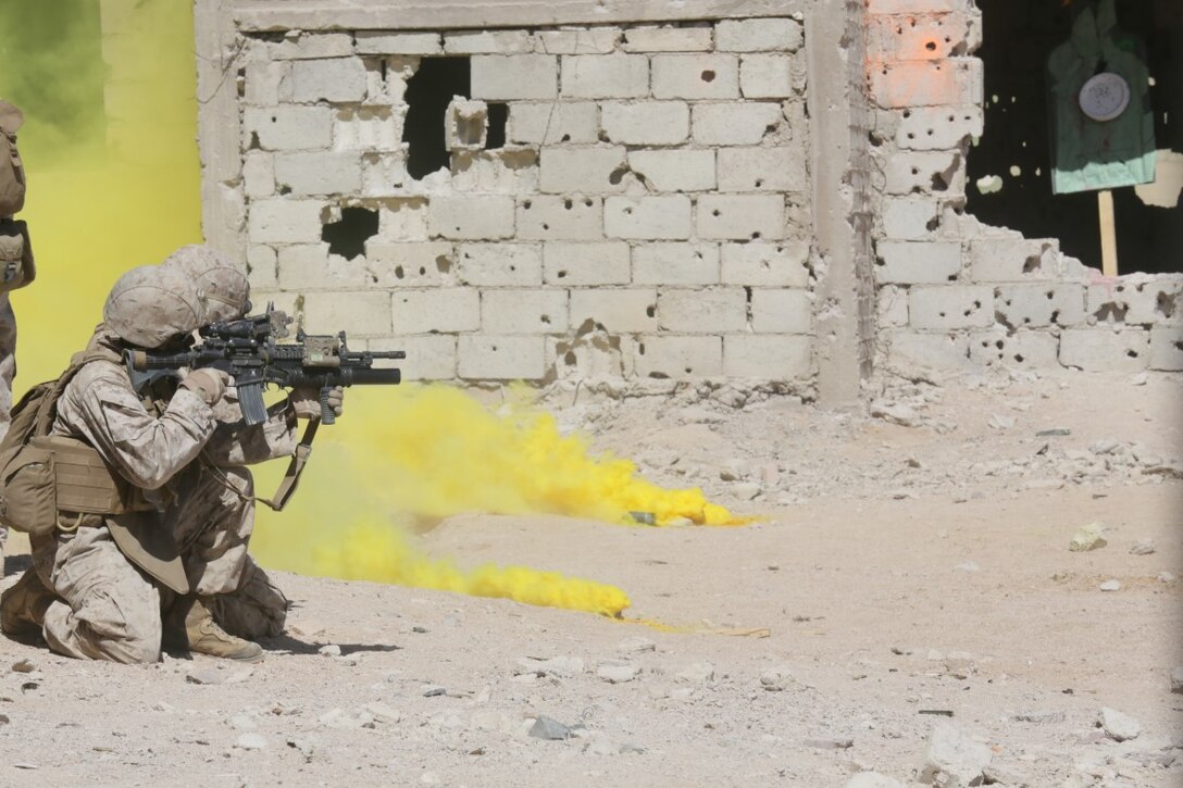 U.S. 5TH FLEET AREA OF OPERATIONS (Sept. 30, 2015)  U.S. Marines with India Company, Battalion Landing Team 3rd Battalion, 1st Marine Regiment, 15th Marine Expeditionary Unit, isolate a neighboring building for a door breach during a military operations in urban terrain exercise. The 15th MEU, embarked aboard the ships of the Essex Amphibious Ready Group, is a forward-deployed, flexible sea-based Marine air-ground task force capable of engaging with regional partners and maintaining regional security.  (U.S. Marine Corps photo by Sgt. Jamean Berry/Released)