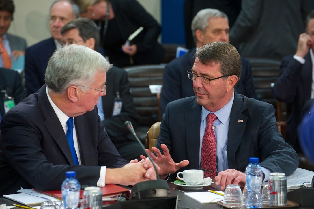 U.S. Defense Secretary Ash Carter speaks with British Defense Secretary Michael Fallon before the NATO defense ministers meeting in Brussels, Oct. 8, 2015. NATO photo