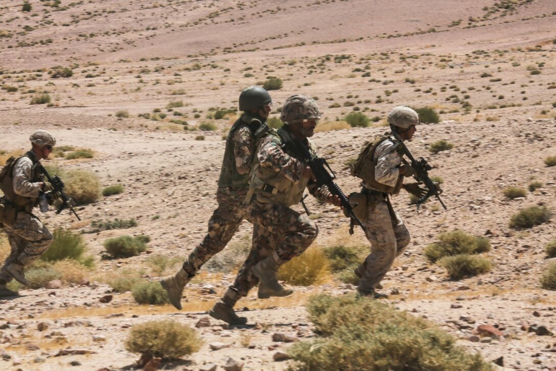 U.S. 5TH FLEET AREA OF RESPONSIBILITY (Aug. 25, 2015) Jordanian Soldiers and U. S. Marines with India Company, Battalion Landing Team 3rd Battalion, 1st Marine Regiment, 15th Marine Expeditionary Unit, rush to their next firing position during a bi-lateral training exercise. The 15th MEU is deployed throughout the U.S. 5th Fleet area of operations area of responsibility to maintain regional security. (U.S. Marine Corps photo by Sgt. Jamean Berry/Released)