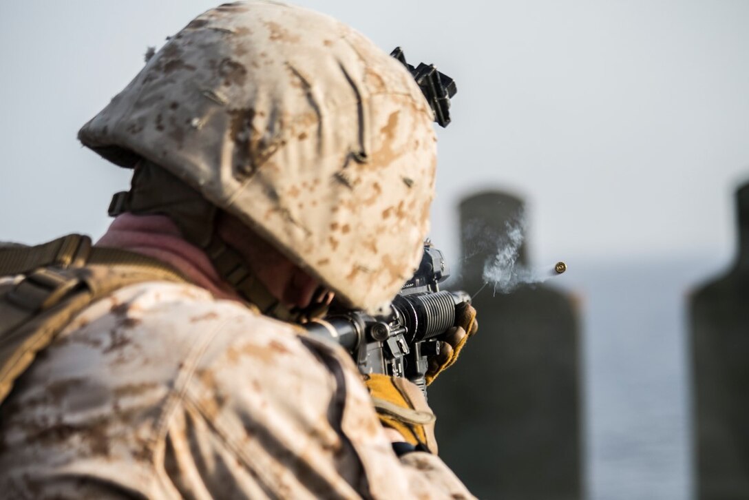 ARABIAN GULF (Oct. 7, 2015) U.S. Marine Sgt. Drew Renwick fires at his target during a deck shoot aboard the amphibious assault ship USS Essex (LHD 2). Renwick is a mortar chief with India Battery, Battalion Landing Team 3rd Battalion, 1st Marine Regiment, 15th Marine Expeditionary Unit. The Marines practiced different pivoting drills as well as shooting on the move in order to enhance their marksmanship skills. The 15th MEU, embarked aboard the ships of the Essex ARG, is deployed to maintain regional security in the U.S. 5th Fleet area of operations. (U.S. Marine Corps photo by Cpl. Anna Albrecht/Released)