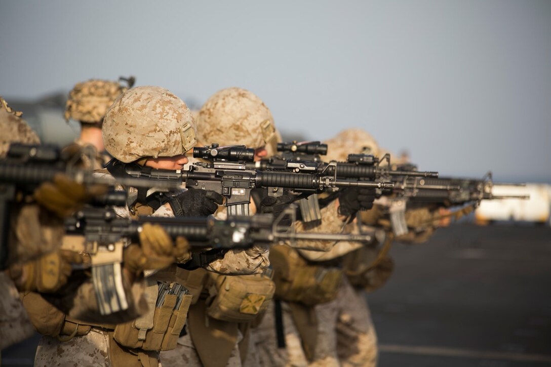 ARABIAN GULF (Oct. 7, 2015) U.S. Marines with India Battery, Battalion Landing Team 3rd Battalion, 1st Marine Regiment, 15th Marine Expeditionary Unit, fire at their targets during a deck shoot aboard the amphibious assault ship USS Essex (LHD 2). The Marines practiced different pivoting drills as well as shooting on the move in order to enhance their marksmanship skills. The 15th MEU, embarked aboard the ships of the Essex ARG, is deployed to maintain regional security in the U.S. 5th Fleet area of operations. (U.S. Marine Corps photo by Cpl. Anna Albrecht/Released)