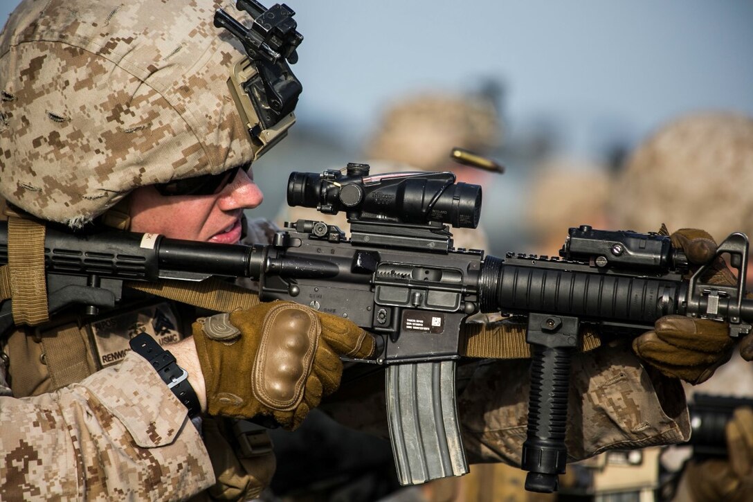 ARABIAN GULF (Oct. 7, 2015) U.S. Marine Sgt. Drew Renwick fires at his target during a deck shoot aboard the amphibious assault ship USS Essex (LHD 2). Renwick is a mortar chief with India Battery, Battalion Landing Team 3rd Battalion, 1st Marine Regiment, 15th Marine Expeditionary Unit. The Marines practiced different pivoting drills as well as shooting on the move in order to enhance their marksmanship skills. The 15th MEU, embarked aboard the ships of the Essex ARG, is deployed to maintain regional security in the U.S. 5th Fleet area of operations. (U.S. Marine Corps photo by Cpl. Anna Albrecht/Released)