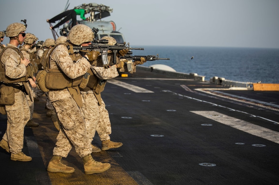 ARABIAN GULF (Oct. 7, 2015) U.S. Marines with India Battery, Battalion Landing Team 3rd Battalion, 1st Marine Regiment, 15th Marine Expeditionary Unit, shoot on the move during a deck shoot aboard the amphibious assault ship USS Essex (LHD 2). The Marines practiced different pivoting drills as well as shooting on the move in order to enhance their marksmanship skills. The 15th MEU, embarked aboard the ships of the Essex ARG, is deployed to maintain regional security in the U.S. 5th Fleet area of operations. (U.S. Marine Corps photo by Cpl. Anna Albrecht/Released)