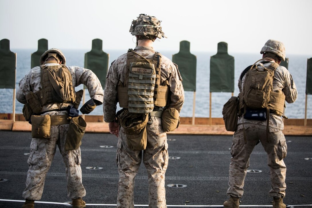 ARABIAN GULF (Oct. 7, 2015) U.S. Marines with India Battery, Battalion Landing Team 3rd Battalion, 1st Marine Regiment, 15th Marine Expeditionary Unit, fire at targets during a deck shoot aboard the amphibious assault ship USS Essex (LHD 2). The Marines practiced different pivoting drills as well as shooting on the move in order to enhance their marksmanship skills. The 15th MEU, embarked aboard the ships of the Essex ARG, is deployed to maintain regional security in the U.S. 5th Fleet area of operations. (U.S. Marine Corps photo by Cpl. Anna Albrecht/Released)