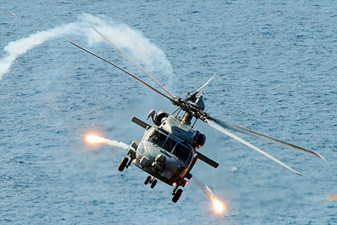 A Navy MH-60R Seahawk helicopter fires flares during a training exercise over the Pacific Ocean, Oct. 6, 2015. The helicopter is attached to Helicopter Maritime Strike 71. U.S. Navy photo by Petty Officer 3rd Class James Vazquez