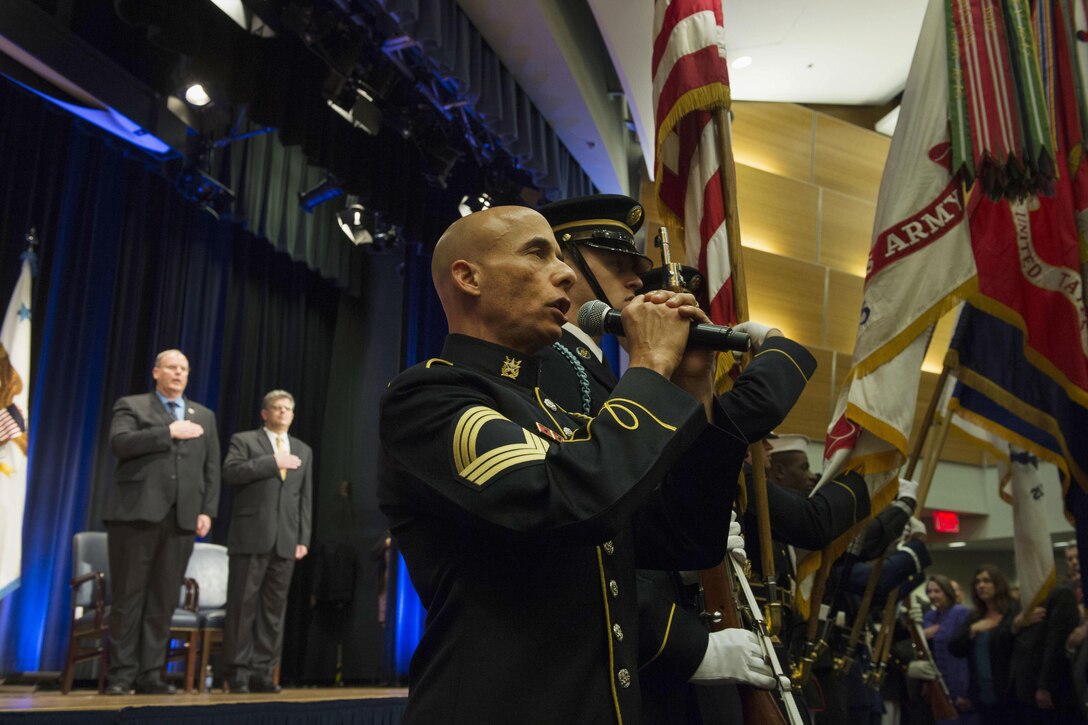 Deputy Defense Secretary Bob Work, left, and Michael L. Rhodes, the Defense Department's director of administration and management, render honors as a soldier sings the national anthem during the department's civilian awards ceremony at the Pentagon, Oct. 8, 2015. DoD photo by U.S. Air Force Senior Master Sgt. Adrian Cadiz