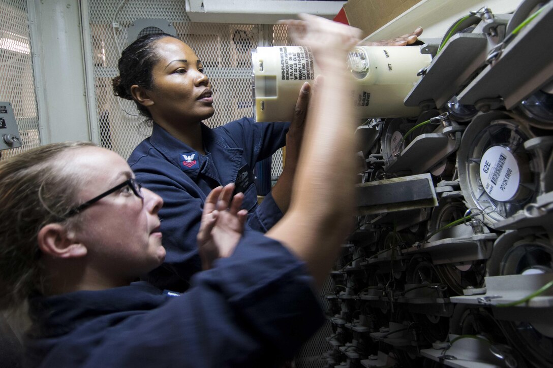 U.S. Navy Petty Officer 2nd Class Melanie Keller left, and Gunner's Mate 1st Class Cheryl Rainy pull out a sonobuoy aboard the USS Porter in the Black Sea, Oct. 7, 2015. The Porter is on a routine patrol conducting naval operations in the U.S. 6th Fleet area of responsibility to support U.S. national security interests in Europe. Keller is a sonar technician; Rainy is a gunner’s mate. U.S. Navy photo by Petty Officer 1st Class Sean Spratt