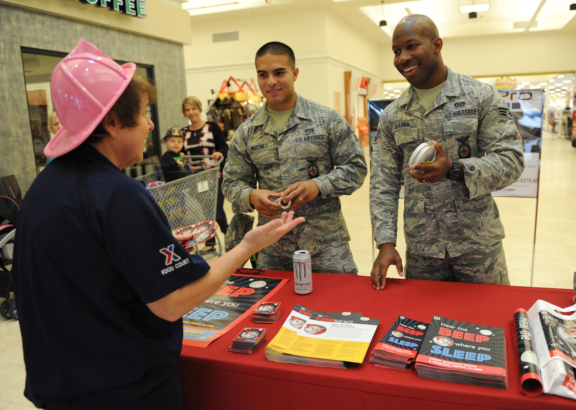 Tammy Palombi, Base Exchange food court manager, receives instruction on when to change fire alarm batteries from Senior Airmen Jonathan Martinez and Kyeonee Russell, 81st Infrastructure Division firefighters, at the Base Exchange during Fire Prevention Week, Oct. 5, 2015, Keesler Air Force Base, Miss. The week-long event includes fire drills, literature hand-outs and stove fire demonstrations around the base and concludes with an open house at the fire department Oct. 10. (U.S. Air Force photo by Kemberly Groue)