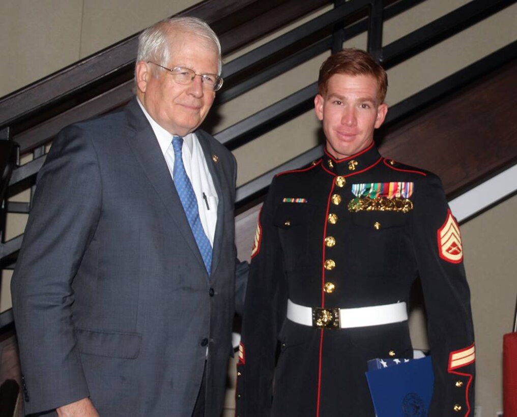 Staff Sgt. Andres Rodriguez receives his award for USO North Carolina Marine of the Year at the 2015 Annual Salute to Freedom Gala in Durham, N.C., Oct. 3, 2015. Congressman David Price, 4th District of NC presented each honoree with The U.S. flag flown over the Capitol in Washington DC.