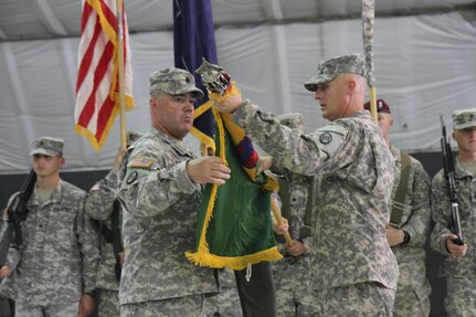 U.S. Army Col. Vernon Simpson (right), commander of the 30th Armored Brigade Combat Team, and U.S. Army Command Sgt. Maj. Ralph Johnson, the 30th ABCT command sergeant major, uncase the brigade’s colors during a Multinational Battle Group-East transfer of authority ceremony July 9, 2015, at Camp Bondsteel, Kosovo. The 30th ABCT, an Army National Guard unit from North Carolina, will lead a multinational force supporting NATO’s peace mission in Kosovo for approximately nine months. (U.S. Army Photo by Sgt. Erick Yates, Multinational Battle Group-East)