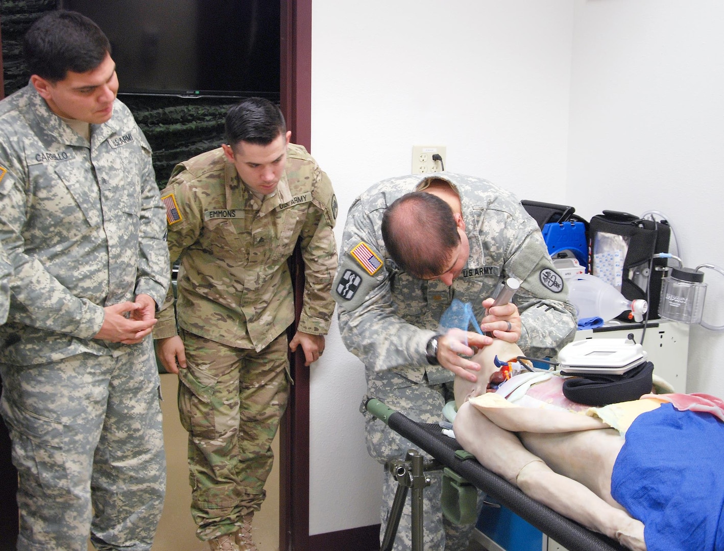 Maj. Steve Carrol (right) teaches airway techniques on synthetic cadavers as students (from left) Sgts. Eric Emmons and Javier Carrillo observe.